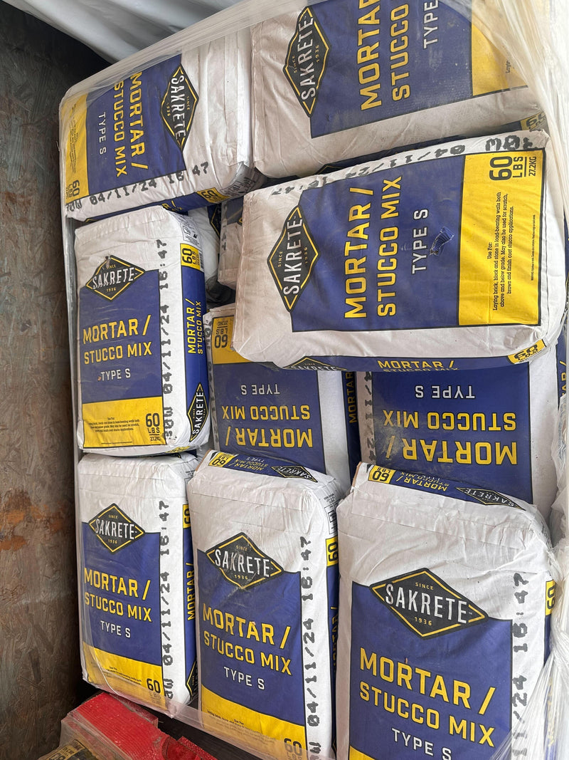 A pallet filled with stacked bags of Sakrete Mortar/Stucco Mix Type S, still slightly wrapped in plastic.